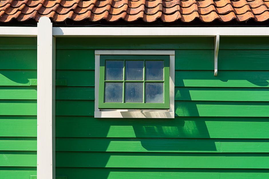 Painted house with a small window and a tile roof