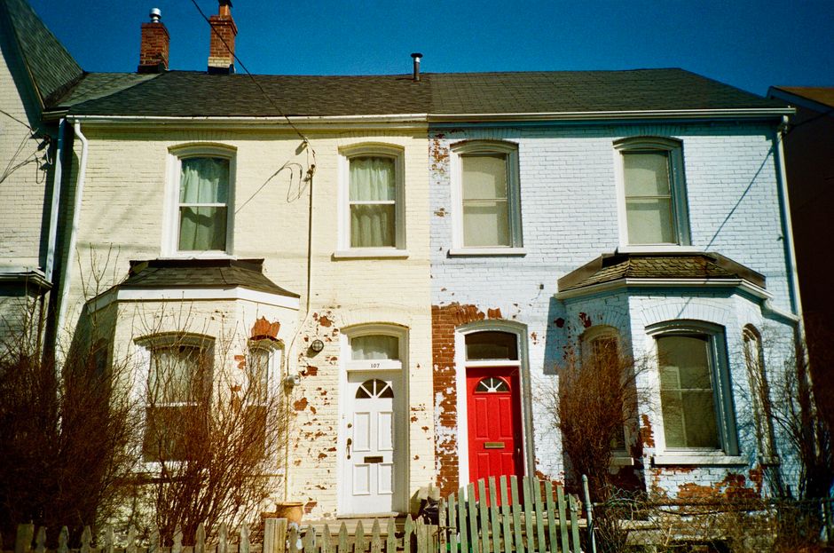 Painted brick houses with brightly coloured front doors