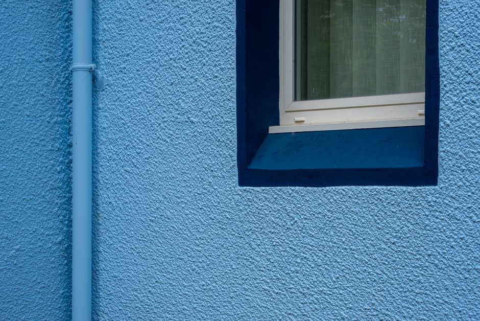 Close-up of a freshly painted textured wall with a window