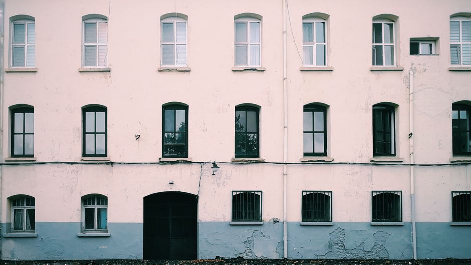 Painted building facade with evenly spaced windows
